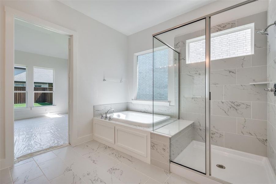 Bathroom with shower with separate bathtub, tile patterned floors, and plenty of natural light