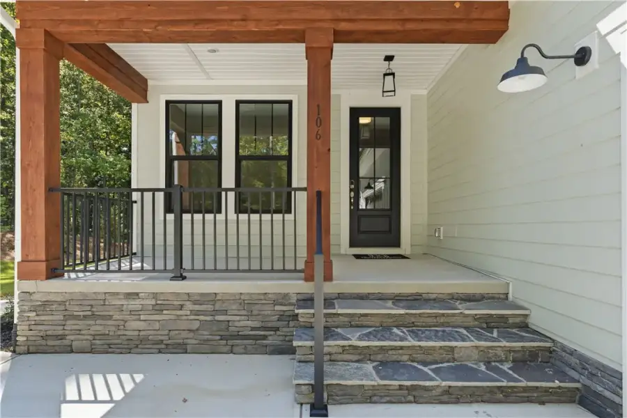 Natural stone steps lead up to a welcoming front p