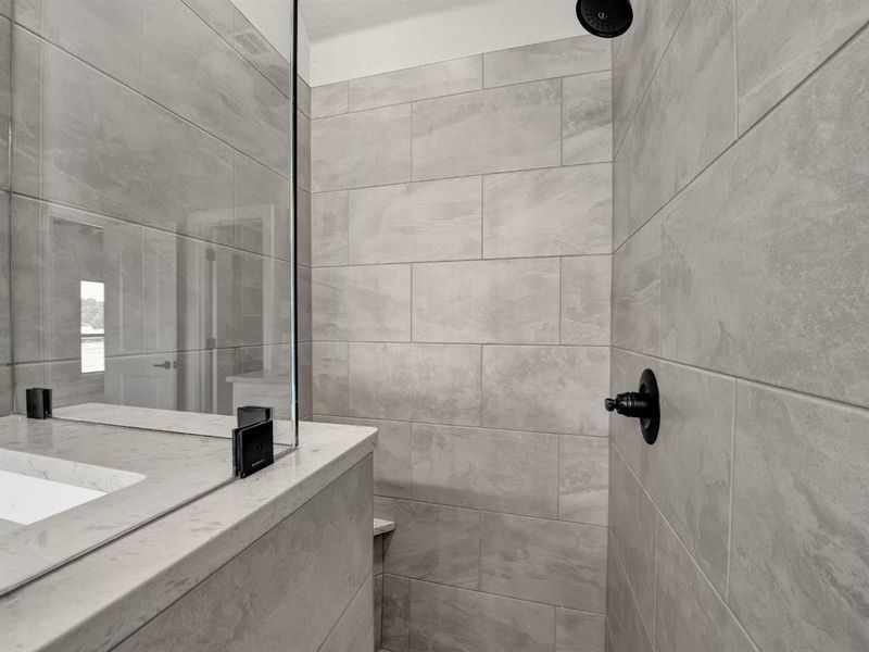 Bathroom featuring a tile shower Bathroom featuring a tile shower