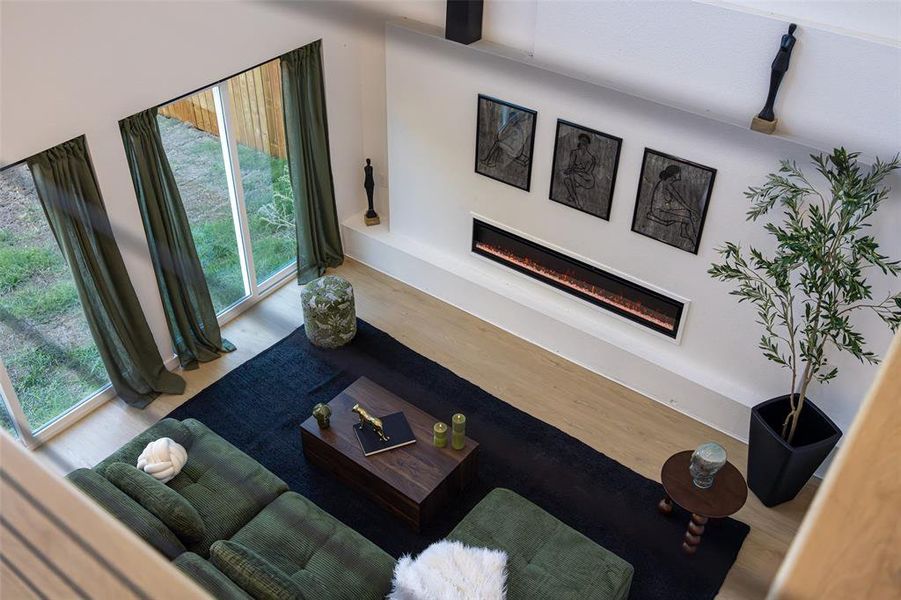 Living area featuring a glass covered fireplace and wood finished floors