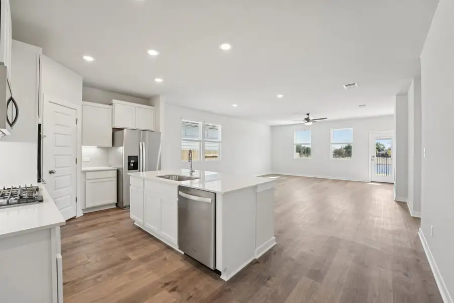A kitchen with white cabinets.