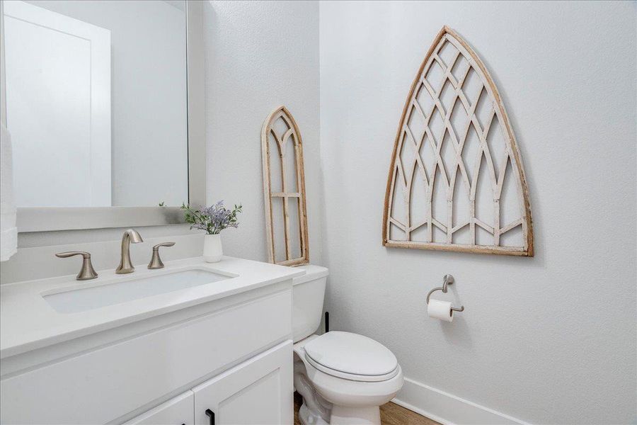 Half bathroom with vanity and toilet Half bathroom with vanity and toilet