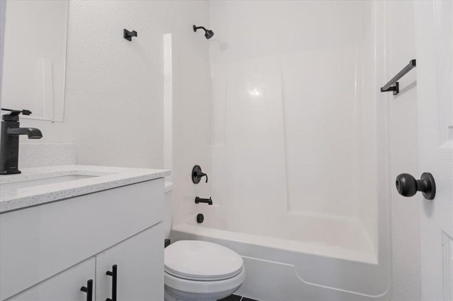 Full bathroom with shower / bath combination, toilet, and vanity