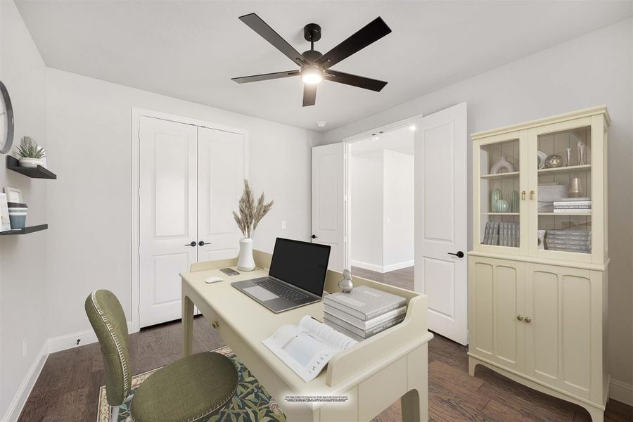 Home office with cream desk, laptop, display cabinet, ceiling fan, and dark hardwood floors