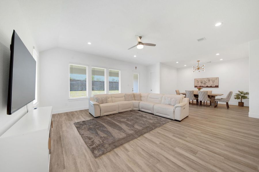 The spacious island serves as a perfect gathering spot for guests while the chef prepares meals.