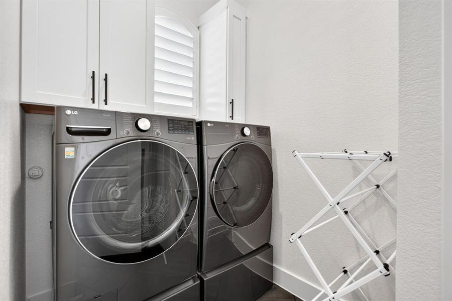 Laundry room is pretty awesome with upper cabinets, a sweet little window, and a broom - linen closet. Laundry room is pretty awesome with upper cabinets, a sweet little window, and a broom - linen closet.