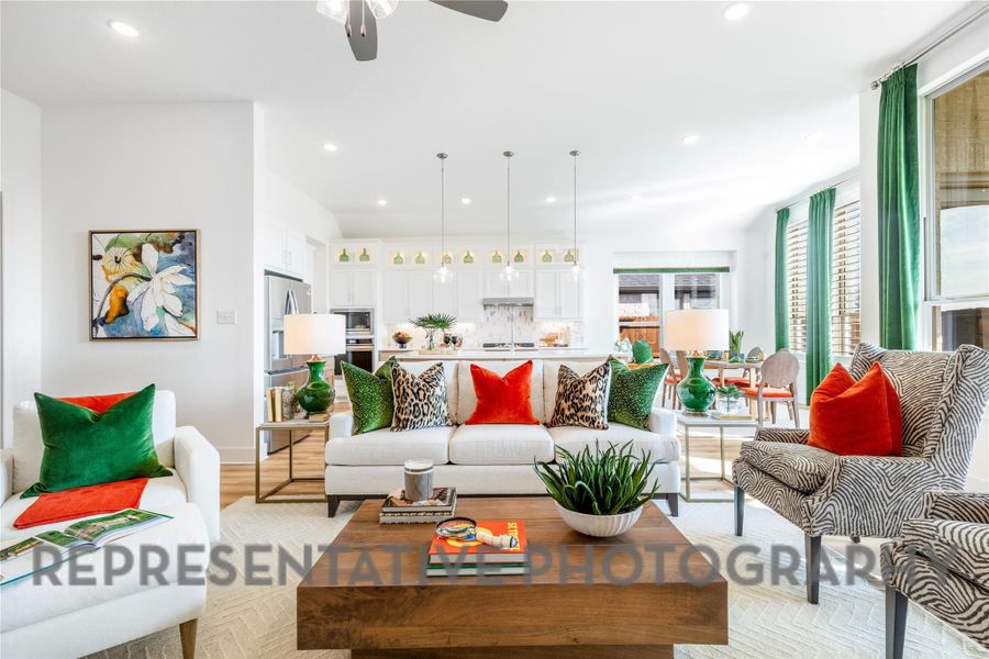 Living room featuring a ceiling fan, baseboards, recessed lighting, and light wood-type flooring Living room featuring a ceiling fan, baseboards, recessed lighting, and light wood-type flooring
