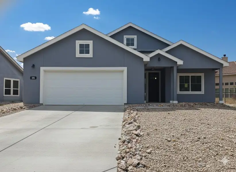 View of front facade featuring concrete driveway and stucco siding