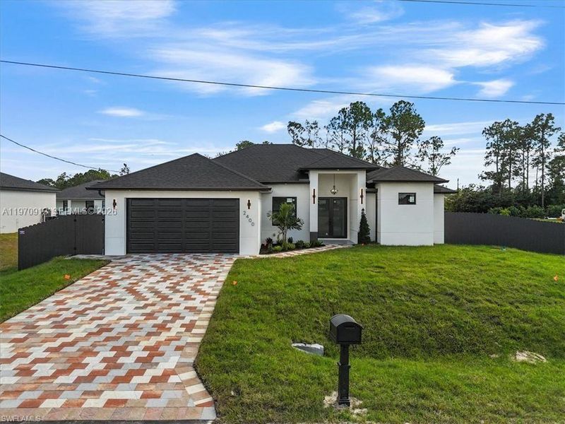 Front exterior of a new home in , Lehigh Acres, FL, highlighting curb appeal (Image 18).