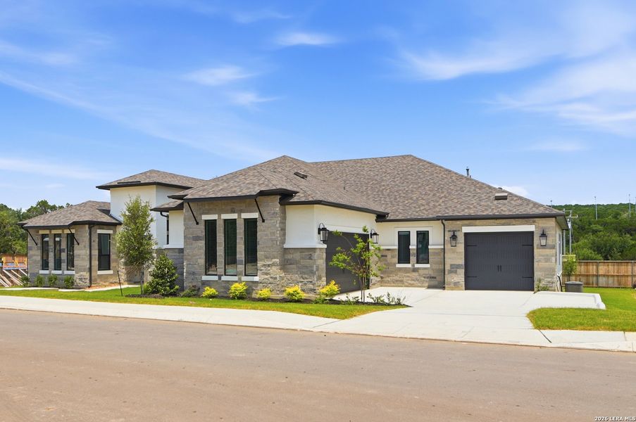 Front exterior of a new home in Shavano Highlands, San Antonio, TX, highlighting curb appeal (Image 1). Front exterior of a new home in Shavano Highlands, San Antonio, TX, highlighting curb appeal (Image 1).