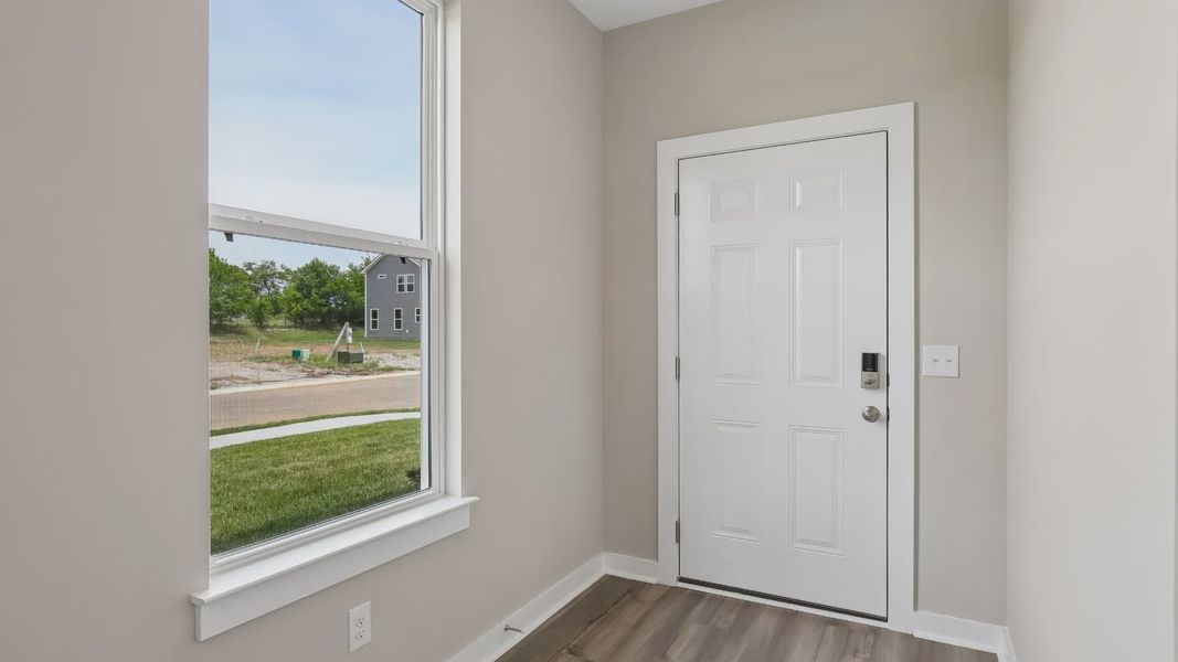 Front Door to home with nearby window Front Door to home with nearby window
