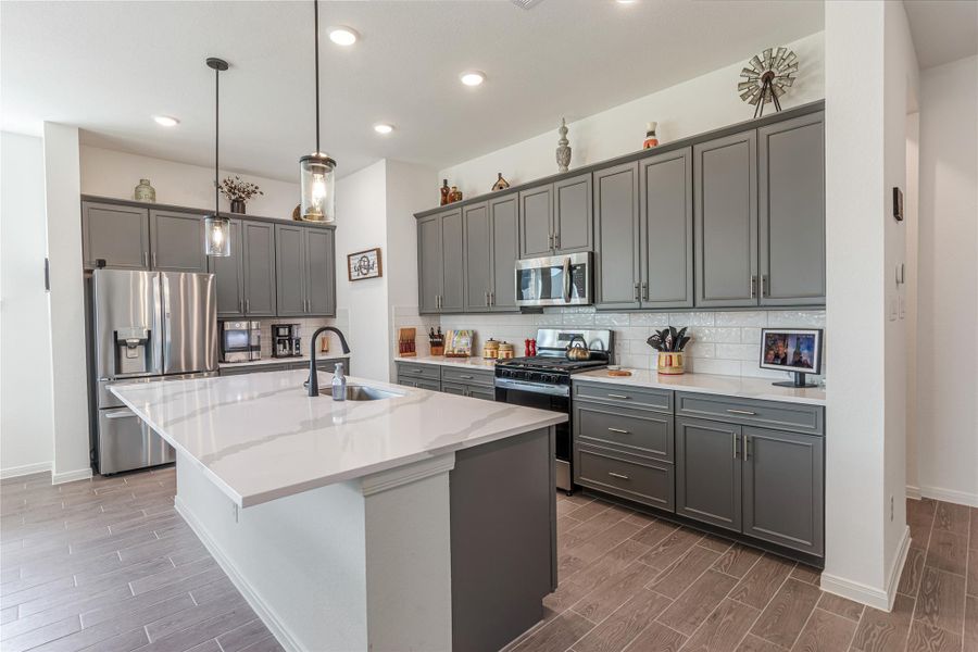 Another view of this modern kitchen...so much cabinet space featuring pots/pan drawers, pull out double trash cabinet.
