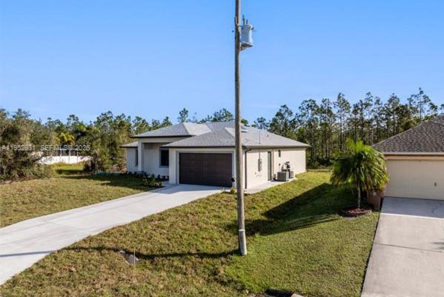 Front exterior of a new home in , Lehigh Acres, FL, highlighting curb appeal (Image 19). Front exterior of a new home in , Lehigh Acres, FL, highlighting curb appeal (Image 19).