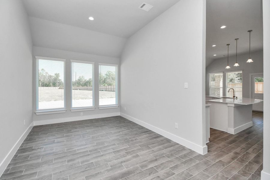 Make memories gathered around the table with your family and friends! This spacious dining room features elegant flooring, custom paint, and adjacent to family room and kitchen for open concept feel. Sample photo of completed home with similar floor plan. Actual colors and selections may vary. Make memories gathered around the table with your family and friends! This spacious dining room features elegant flooring, custom paint, and adjacent to family room and kitchen for open concept feel. Sample photo of completed home with similar floor plan. Actual colors and selections may vary.