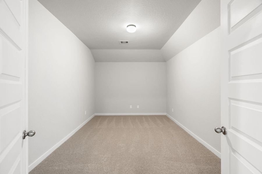 Adjacent to the game room, are the doors to enter into your own media room. Ideal for staying in on weekends and enjoying a film within the comfort of your home. Sample photo of completed home with similar floor plan. As-built interior colors and selections may vary.