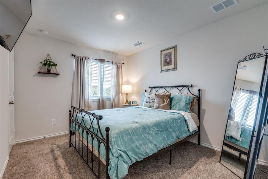 Bedroom with carpet floors and baseboards Bedroom with carpet floors and baseboards