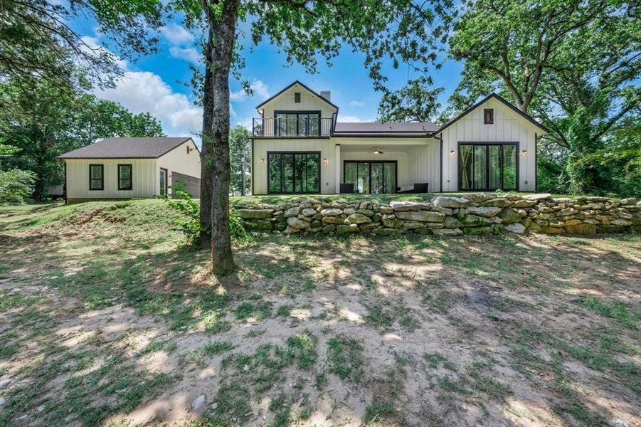 Rear view of property with a patio and a balcony Rear view of property with a patio and a balcony