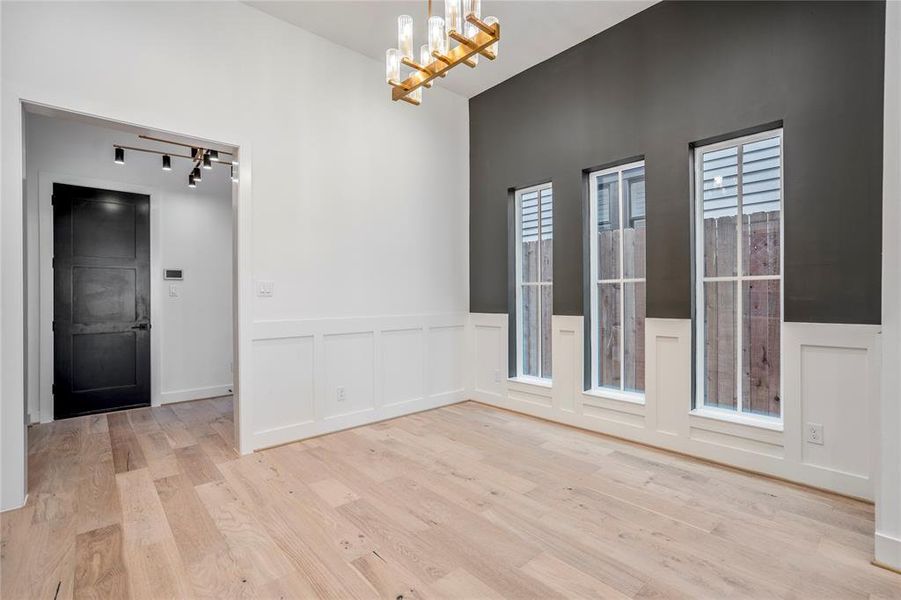 Closer look at the custom chandelier in this dining space. Custom chair railing defines your dining room.