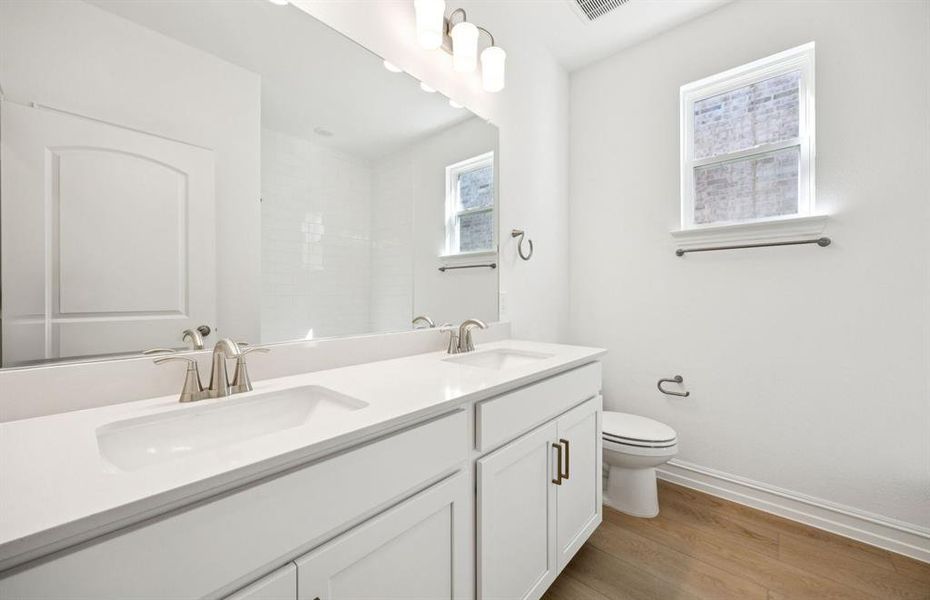 Secondary bath with natural light and double sinks Secondary bath with natural light and double sinks