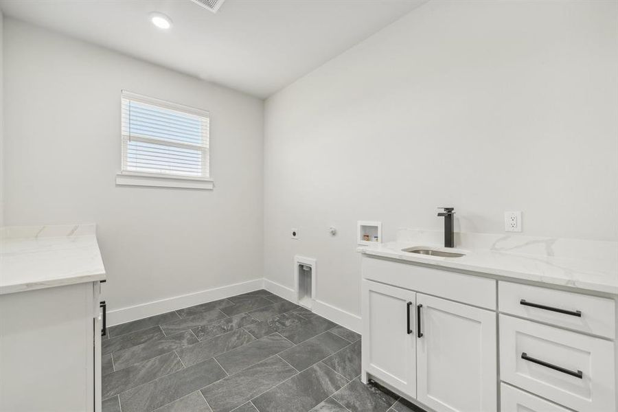 Laundry area featuring hookup for a gas dryer, hookup for an electric dryer, sink, washer hookup, and cabinets