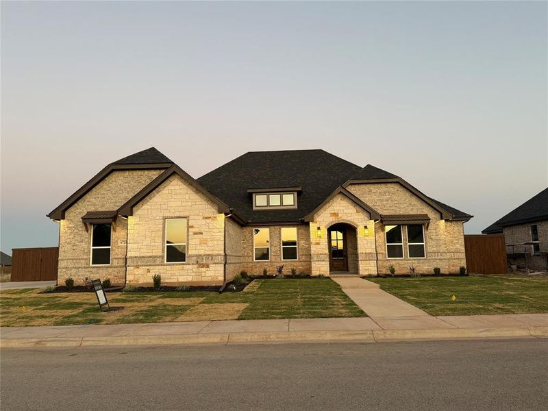 View of front of home featuring stone siding and roof with shingles View of front of home featuring stone siding and roof with shingles