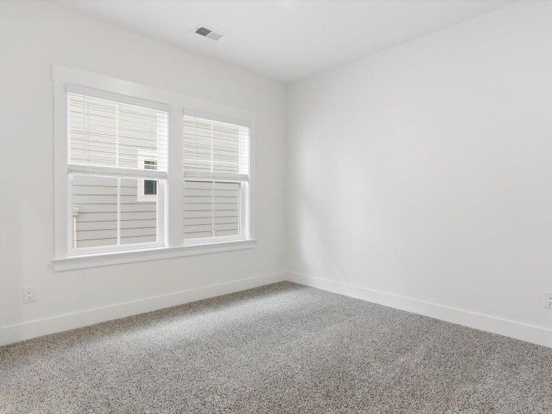 Spacious, unfurnished interior of a new home in The Coves at Lakes of Cane Bay, Summerville (Image 37).