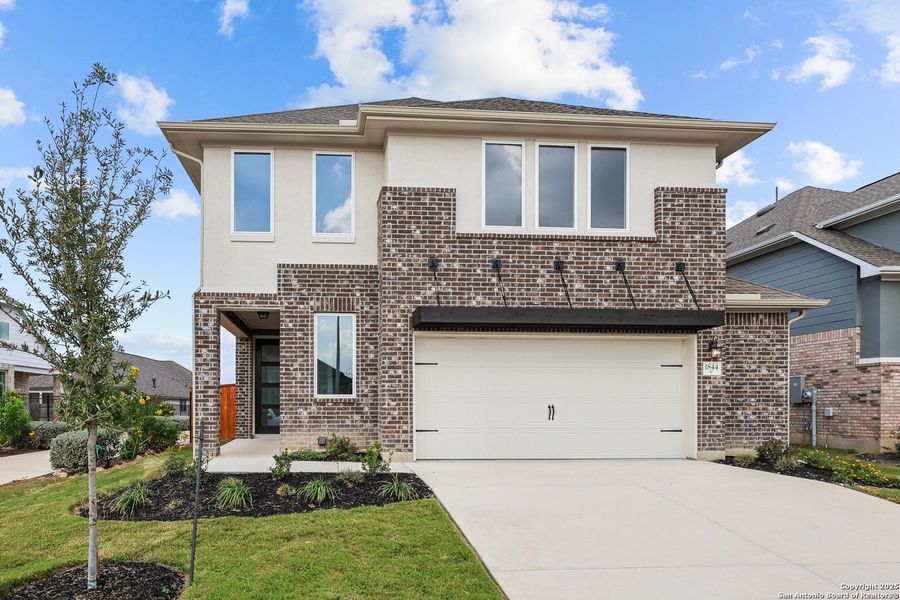 Front exterior of a new home in Veramendi, New Braunfels, TX, highlighting curb appeal (Image 2).