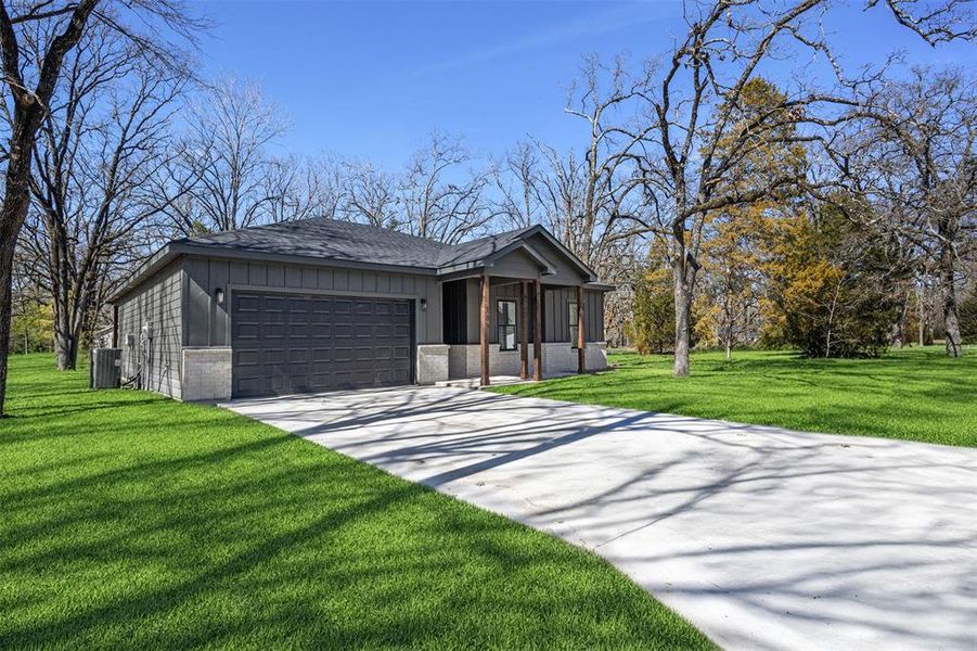 Front exterior of a new home in , Payne Springs, TX, highlighting curb appeal (Image 25). Front exterior of a new home in , Payne Springs, TX, highlighting curb appeal (Image 25).