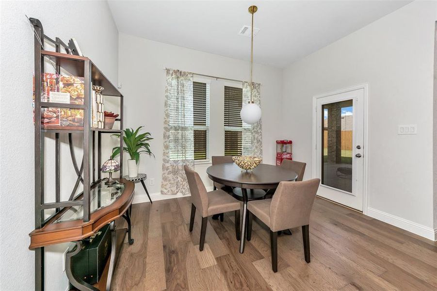 Dining area featuring hardwood / wood-style floors and plenty of natural light