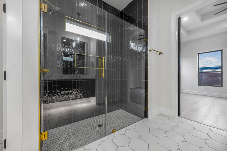 Full bathroom with a shower stall, patterned tile flooring, and recessed lighting. Full bathroom with a shower stall, patterned tile flooring, and recessed lighting.