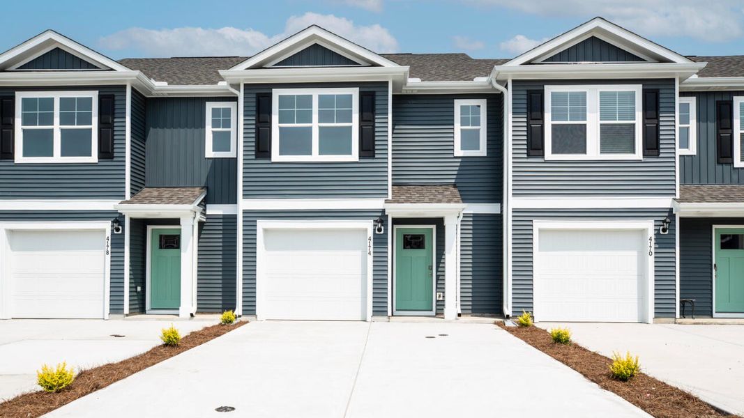 Front exterior of a new home in Waterside Townhomes, Surf City, NC, highlighting curb appeal (Image 1).