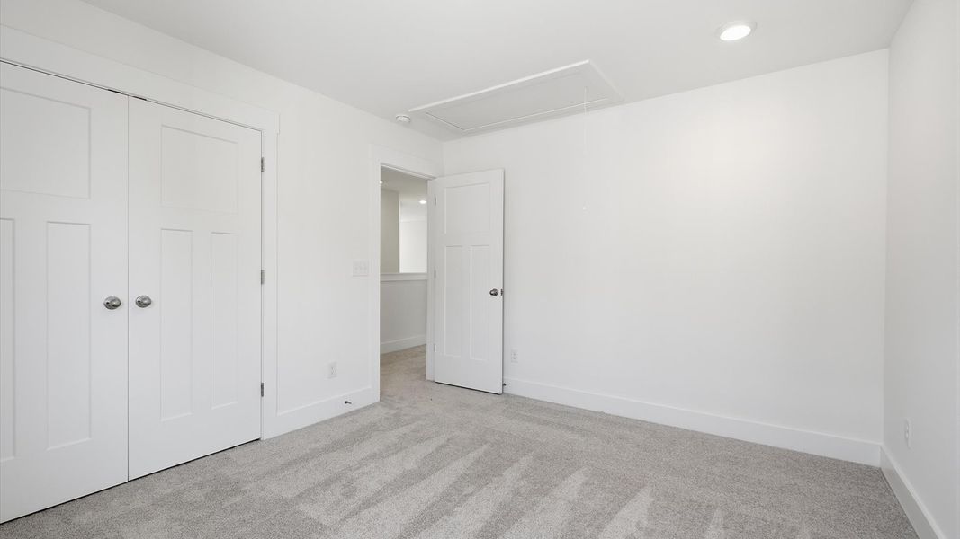 First-class secondary bedroom with comfortable carpeted flooring and generous closet space located in Moore, SC