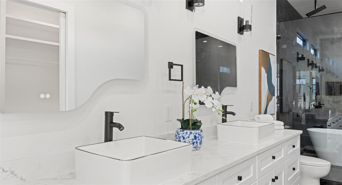 Bathroom with a freestanding tub, double vanity, and a stall shower