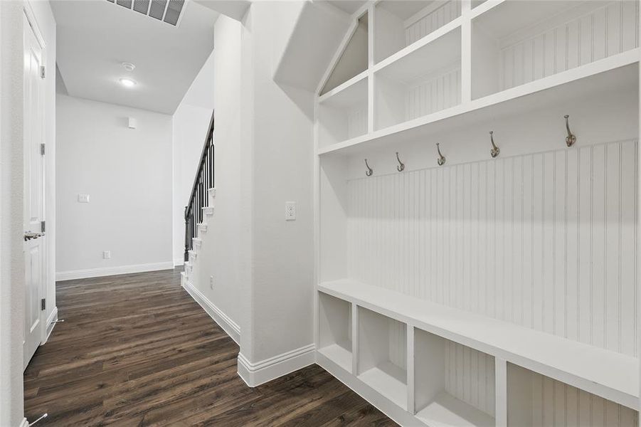 Mudroom featuring baseboards, visible vents, and dark wood-style flooring