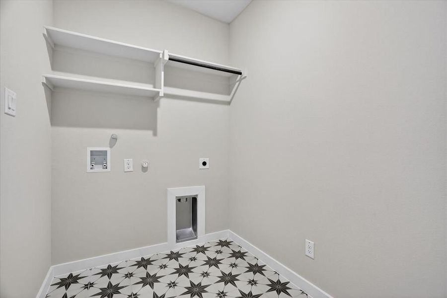 Laundry room featuring star-patterned floor tiles and light neutral walls