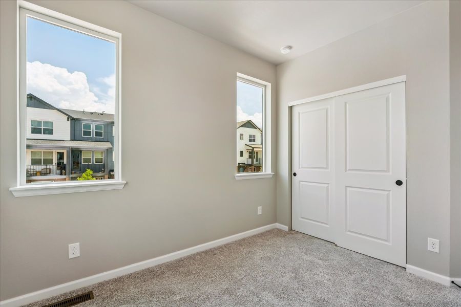 A room with white doors and a window.