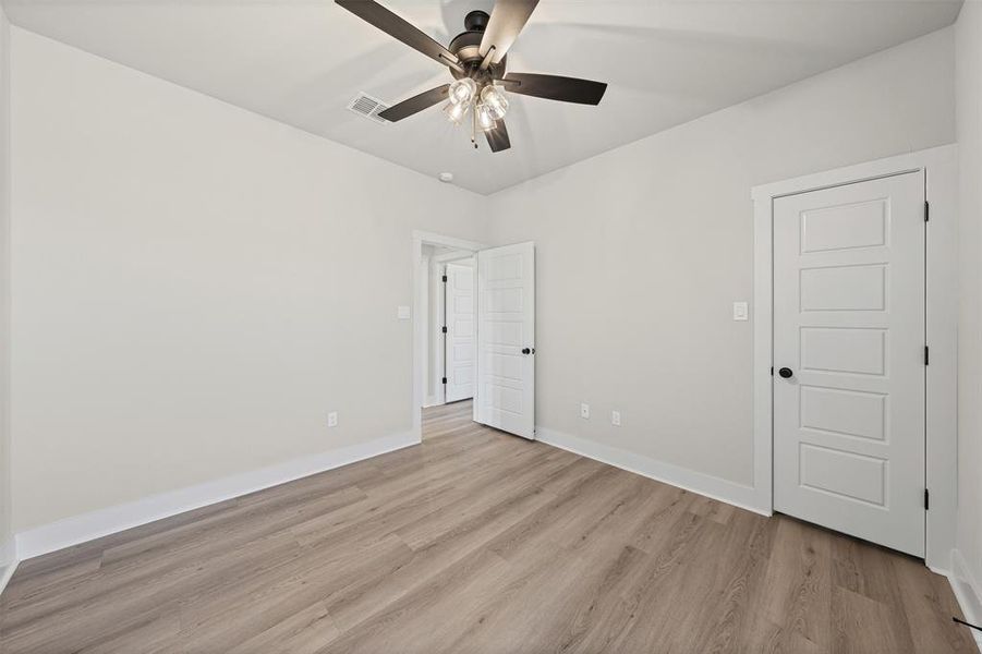 Unfurnished bedroom with light wood finished floors and ceiling fan