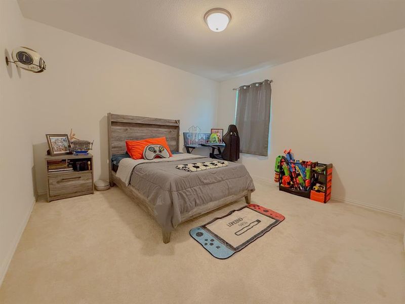 Carpeted bedroom featuring baseboards