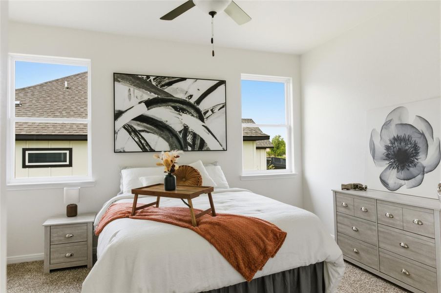 Bedroom with light colored carpet and ceiling fan