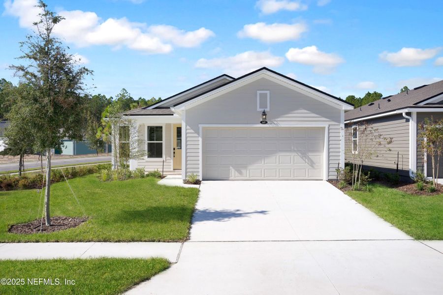 Front exterior of a new home in RiverTown - WaterSong, St. Johns, FL, highlighting curb appeal (Image 16).
