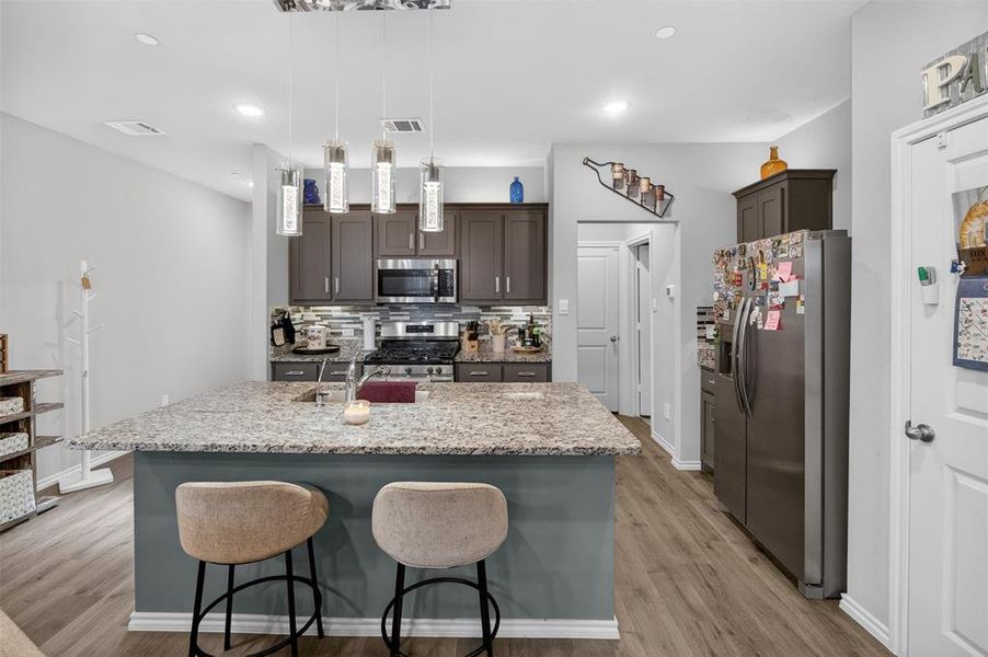 ANOTHER VIEW OF THE KITCHEN WITH STAINLESS STEEL APPLIANCES