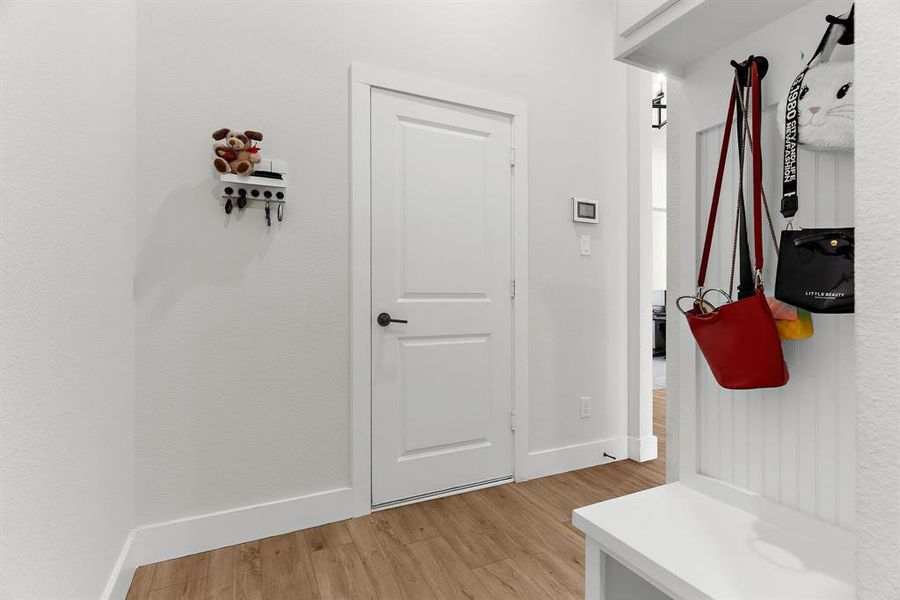 Mudroom with light wood-style floors and baseboards Mudroom with light wood-style floors and baseboards