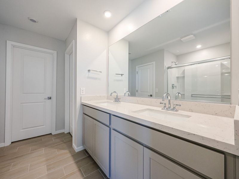 A bathroom with a large mirror. A bathroom with a large mirror.