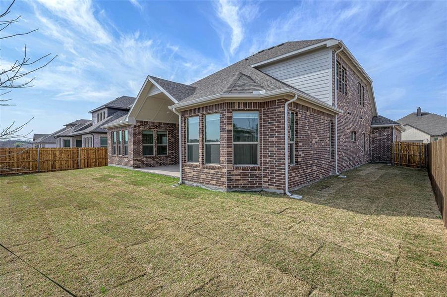 Exterior details and patio area of a home in Estates at Baker Park, Sherman (Image 19).