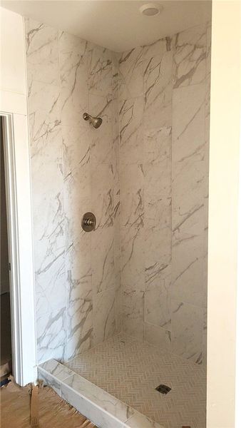 Veined stone tile highlights this walk-in shower f Veined stone tile highlights this walk-in shower f
