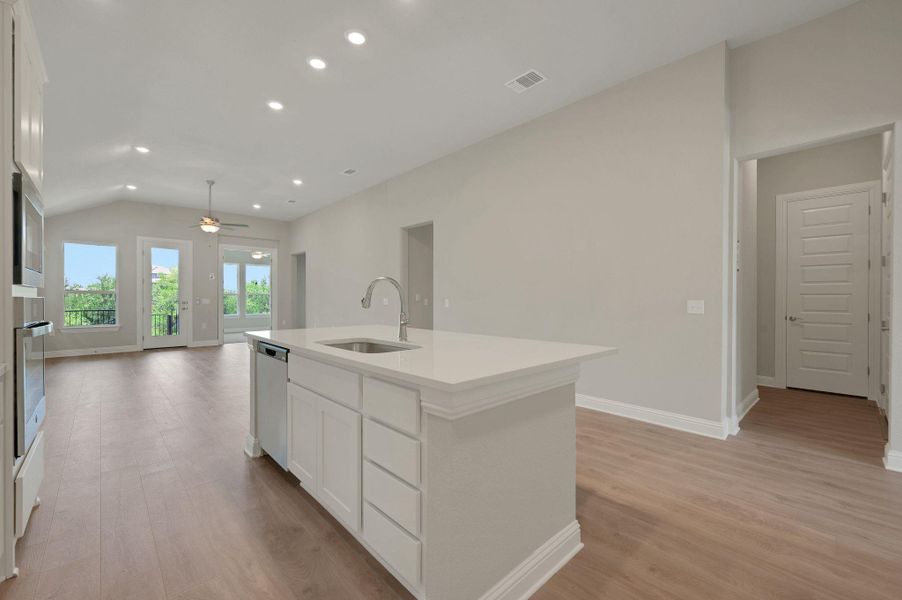 Kitchen featuring appliances with stainless steel finishes, ceiling fan, light wood-type flooring, recessed lighting, and white cabinetry Kitchen featuring appliances with stainless steel finishes, ceiling fan, light wood-type flooring, recessed lighting, and white cabinetry