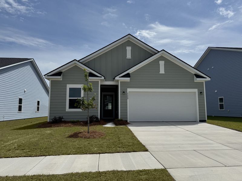 Front exterior of a new home in Tea Farm, Ravenel, SC, highlighting curb appeal (Image 1). Front exterior of a new home in Tea Farm, Ravenel, SC, highlighting curb appeal (Image 1).