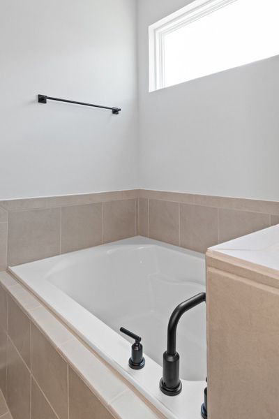 A bathtub in a bathroom. A bathtub in a bathroom.