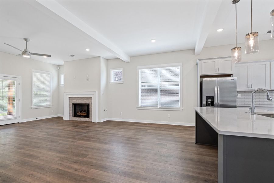 Dual tone kitchen with stainless steel fridge, two tone cabinets, pendant lighting, a ceiling fan, and beamed ceiling Dual tone kitchen with stainless steel fridge, two tone cabinets, pendant lighting, a ceiling fan, and beamed ceiling