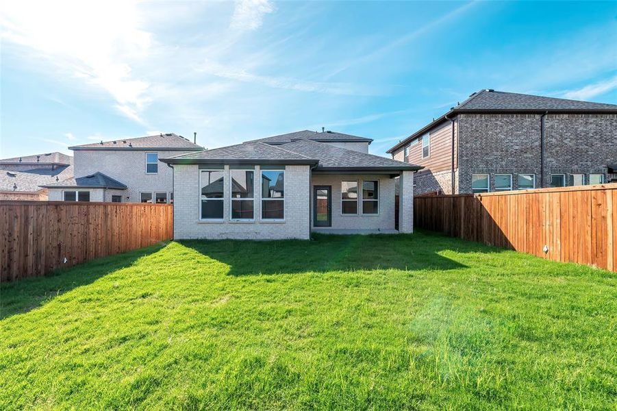 Back of house with brick siding and a shingled roof Back of house with brick siding and a shingled roof
